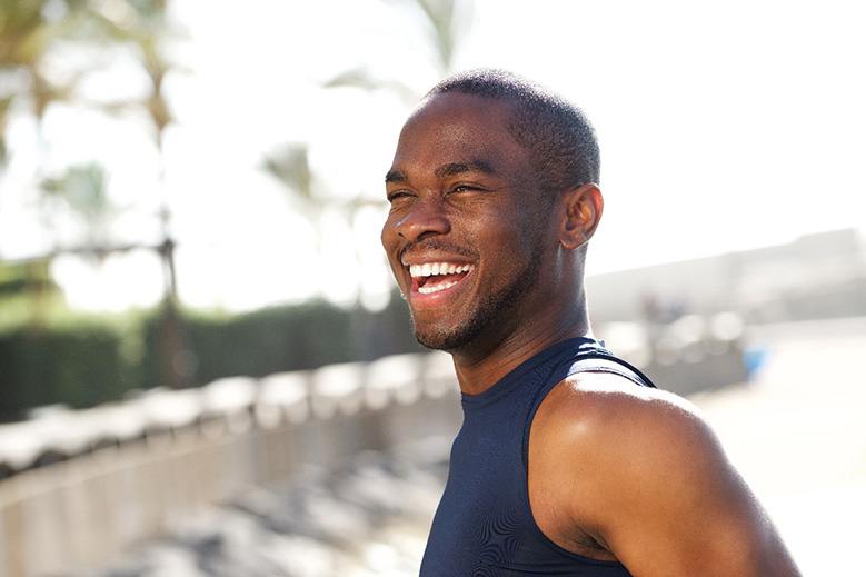 Man outside and smiling with dental crowns in North York, ON