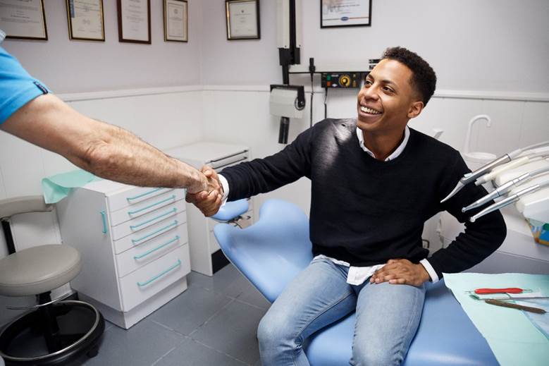 patient shaking dentist in North York hand