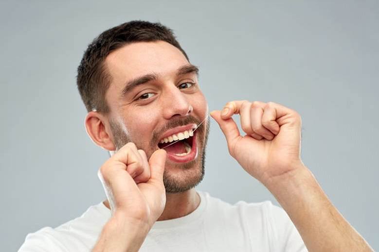 man with tooth-coloured fillings in North York flossing