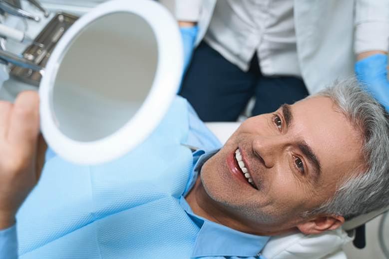 Man admiring his new smile with veneers in North York 