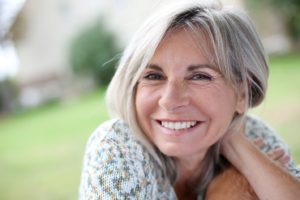 woman with dental implants smiling